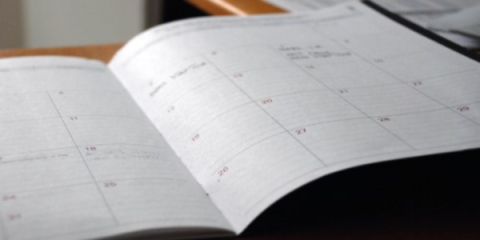 an open planner with calendar dates; photo by Eric Rothermel on Unsplash